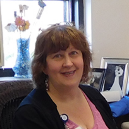 Debi Wright at desk in GME office 2016 204x231