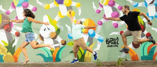 Jeni Godlesky and family in front of a mural by Koctel (of Madrid, Spain) in Flint, Mich. (Photo courtesy of Michael A. Naddeo)